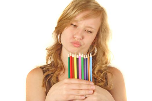 A young handsome woman chooses a colored crayon. All isolated on white background.