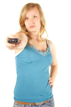 A young handsome woman using a remote control. All isolated on white background.