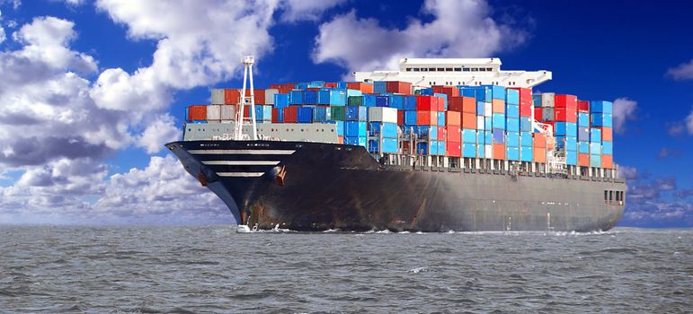A loaded containership navigates across the ocean.