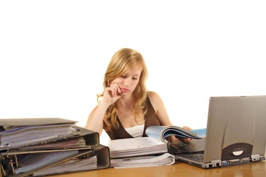 A young ambitious woman in front of her notebook computer. All isolated on white background.