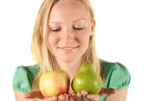 A young handsome woman holding an apple and a pear. All isolated on white background.