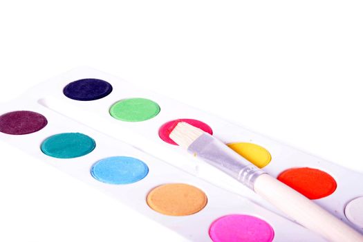 A paintbox and a paintbrush on an isolated white background.