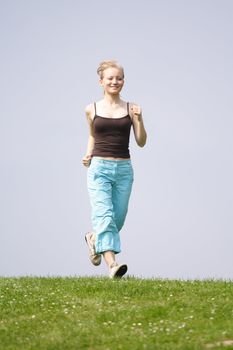 A handsome young woman running on a green meadow.
** Note: Slight blurriness, best at smaller sizes.