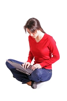 Attractive young woman using laptop. All on white background.