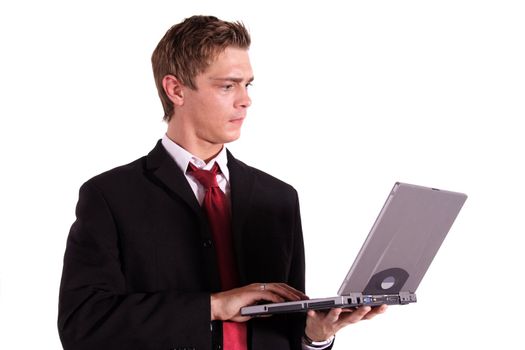 A motivated businessman working on his notebook computer. All isolated on white background.