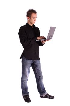 A young handsome man surfing the internet with his notebook computer. All isolated on white background.