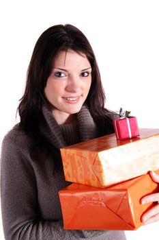 A handsome young woman holding a pile of presents. All isolated on white background.