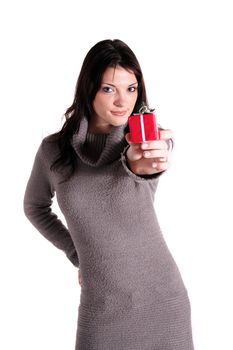 A handsome young woman holding a small red present. All isolated on white background.