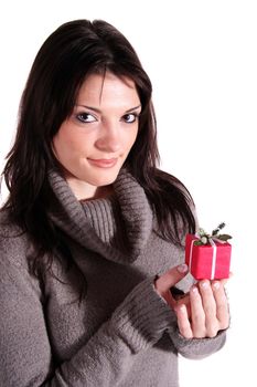 A handsome young woman holding a small red present. All isolated on white background.