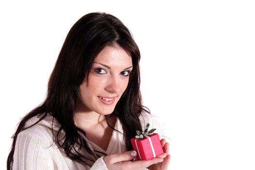 A handsome young woman holding a small red present. All isolated on white background.