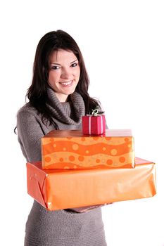 A handsome young woman holding a pile of presents. All isolated on white background.