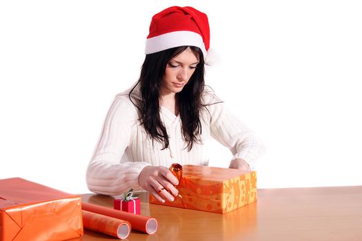 A handsome young woman wrapping presents. All isolated on white background.
