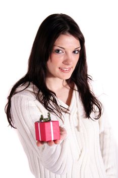 A handsome young woman holding a small red present. All isolated on white background.