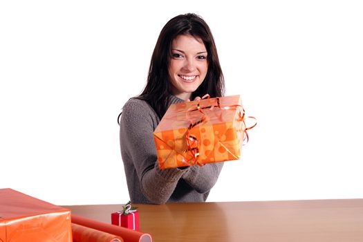 A handsome young woman wrapping presents. All isolated on white background.