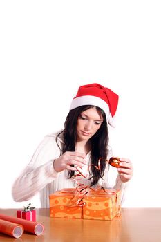 A handsome young woman wrapping presents. All isolated on white background.