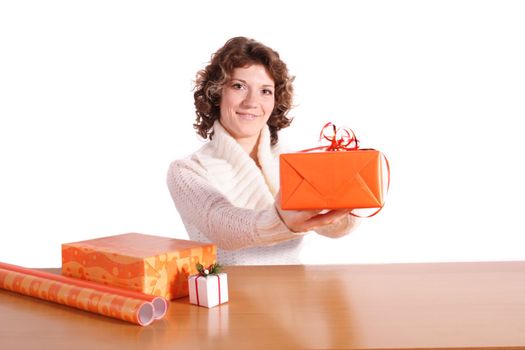 A handsome young woman wrapping presents. All isolated on white background.