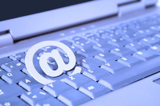 A web symbol lying on the keyboard of a notebook computer.