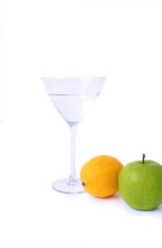 A cocktail glass with an orange and an apple. All isolated on white background.