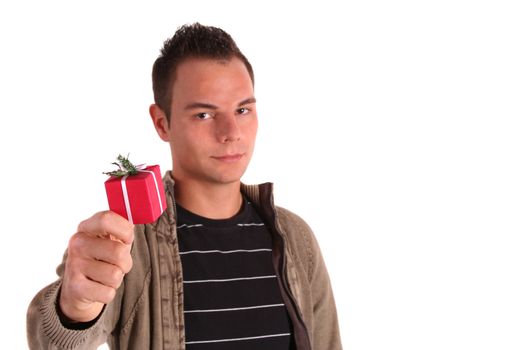 A young handsome man holding a small red present. All isolated on white background.