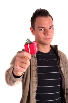 A young handsome man holding a small red present. All isolated on white background.
** Note: Shallow depth of field.