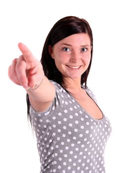 A smiling young woman pointing at someoneor something. All isolated on white background.