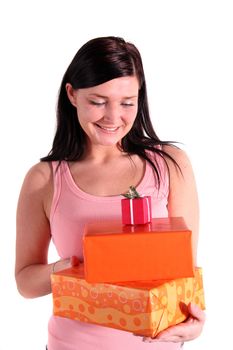 A handsome young woman holding a pile of fine wrapped presents. All isolated on white background.