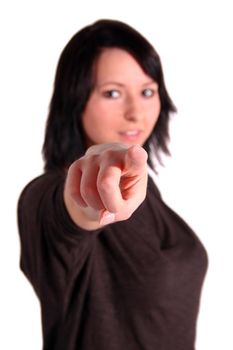 A handsome young woman points with her finger at someone or something. All isolated on white background.