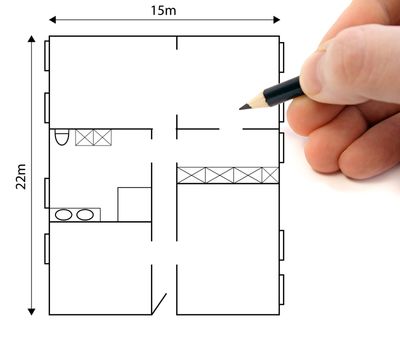 A hand drawing a ground plan to plan a building project.