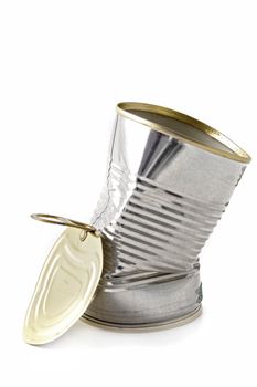 A dented can standing in front of white background.