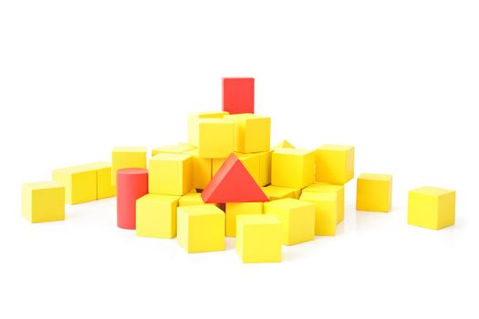 Single red blocks in a pile of yellow ones. All isolated on white background.