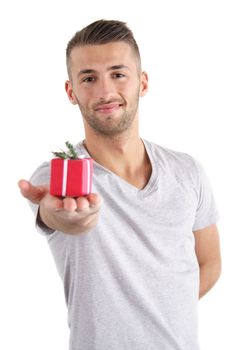 A handsome man handovers a small present. All isolated on white background.