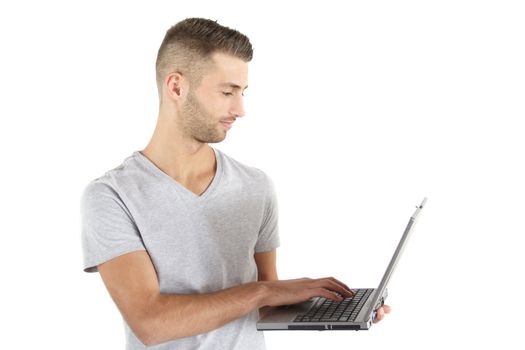 A young handsome man working with his notebook computer. All isolated on white background.