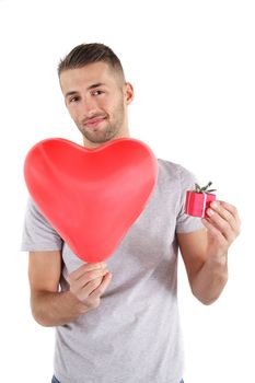 A smarting man handovers a big red heart and a small present. All isolated on white background.