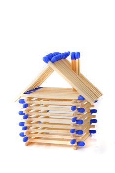 A tinkered house out of matchsticks. All isolated on white background.