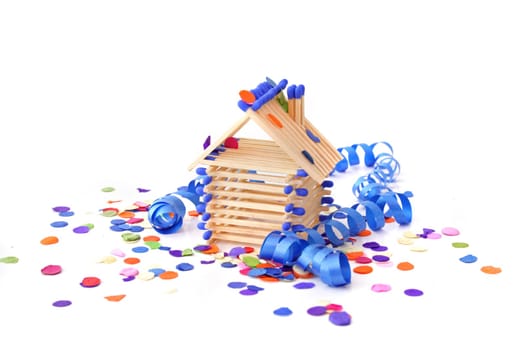 A tinkered house within confetti and streamers. All isolated on white background.