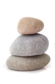 Three fine polished rocks lying one upon another. All isolated on white background.