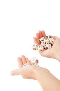 A human hand rolling several dices. All isolated on white background.