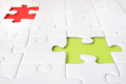 A jigsaw puzzle with a red and green gap.