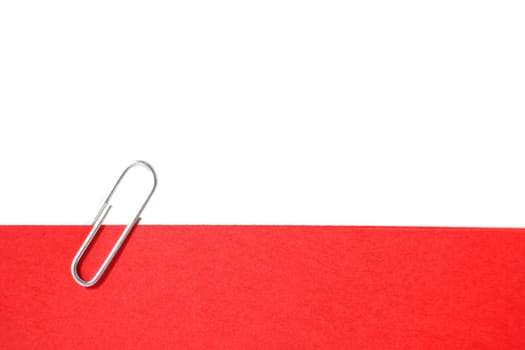 A single paperclip holding a red note. All isolated on white background.