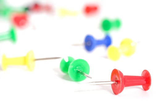 Several pushpins in different colors. All on white background.