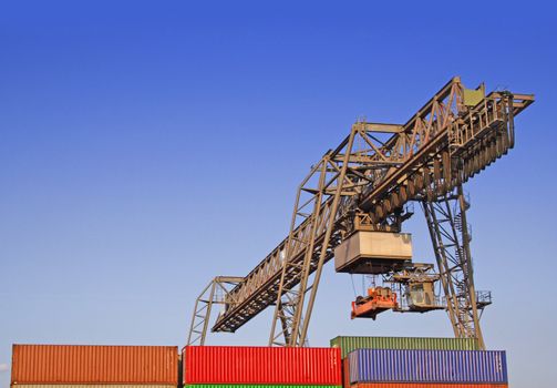 Typical industrial harbor scene in front of a blue sky.