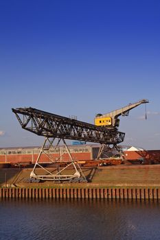 Typical industrial harbor scene in front of a blue sky.