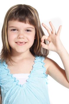 A young girl makes a positive gesture. All isolated on white background.