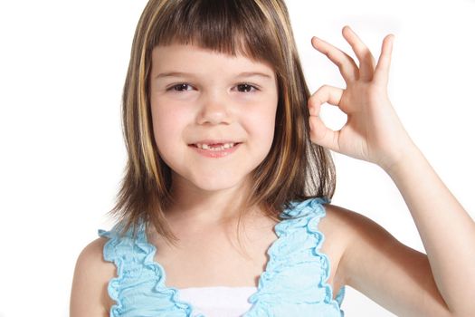 A young girl makes a positive gesture. All isolated on white background.