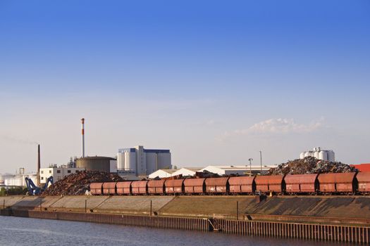 Typical industrial harbor scene in front of a blue sky.