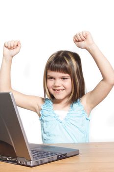 A young girl jubilating in front of her notebook computer. All isolated on white background.