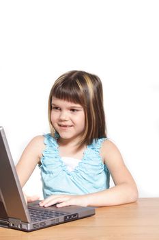 A young girl using a notebook computer. All isolated on white background.