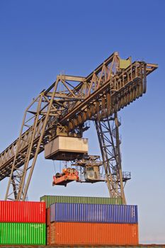 Typical industrial harbor scene in front of a blue sky.