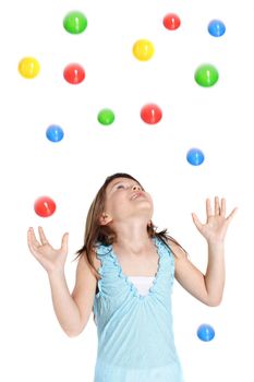 A young girl  catching colored balls. All isolated on white background.