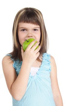 A young girl eating a green apple. All isolated on white background.
